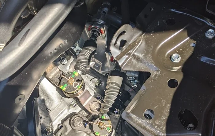 Installed Acuity Instruments shifter cable bushings.